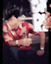 a blurry picture of a man sleeping with the letter p behind him