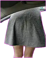 a woman in a gray skirt is standing in a car trunk