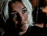a close up of a woman 's face with a black shirt on