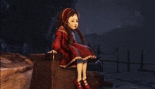 a doll in a red dress is sitting on a box