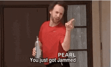 a man in a red shirt is holding a bottle and saying `` you just got jammed '' .