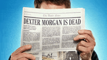 a man is reading a newspaper with the headline dexter morgan is dead