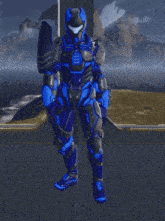 a man in a blue and black armor is standing on a platform