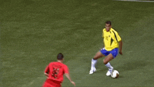 a soccer player in a yellow jersey with the number 10 on it