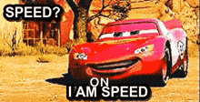 a red car from the movie cars is driving down a dirt road and says `` speed ? on i am speed '' .