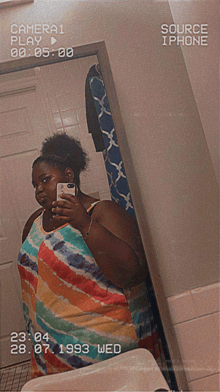 a woman taking a picture of herself in a mirror with the date 28.07.1993