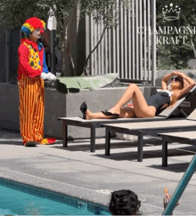 a woman in a bathing suit is laying on a lounge chair next to a clown in a clown suit