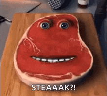 a steak with a face painted on it is sitting on a wooden cutting board .
