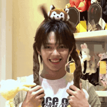 a young man wearing a hat with a monkey on it and a shirt that says peace