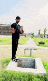 a man in a black shirt is standing on a concrete block in front of a building that says liberty