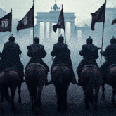 a group of men riding horses holding flags with the letter f on them