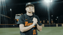 a baseball player holding a bat with the number 10 on his jersey