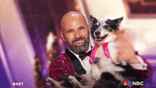 a man in a tuxedo is holding a dog that is wearing a pink tutu .