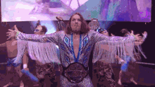 a wrestler with a belt that says world heavyweight championship on it