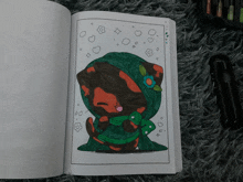 a coloring book is open to a page with a cat wearing a green scarf