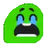 a green smiley face with tears coming out of its eyes and a black mouth .