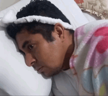 a man wearing a headband is laying on a bed