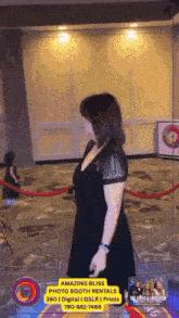 a woman in a black dress is walking down a red carpet with an ad for amazing bliss photo booth rentals