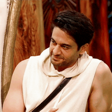 a man in a white tank top with a black strap around his waist