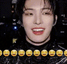 a close up of a man 's face with yellow smiley faces around him .
