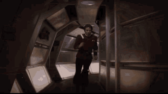 admiral Kirk running down a red dusty hallway in red alert in the Enterprise