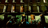 a group of people are standing in front of a large building
