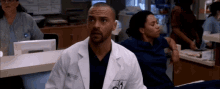 a man in a white lab coat with a name tag that says ' jackson '