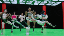 a group of women are dancing together on a green screen