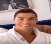 a close up of a man wearing a white robe smiling .