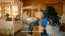 a girl sitting at a desk in a bedroom with the words boyfriends are overrated