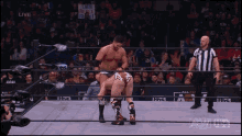 two men in a wrestling ring with a sign that says " suicide squad " on it