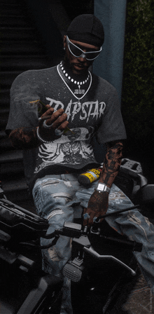 a man is sitting on a motorcycle wearing a trapstar shirt