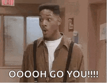 a man in a brown shirt and suspenders is standing in a room with his mouth open and says `` ooooh go you !!! ''