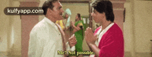 two men are talking to each other in a room and one of them is saying `` me ? not possible '' .