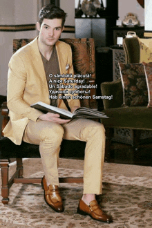 a man in a suit sits in a chair reading a magazine