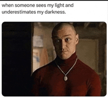 a man wearing a red turtleneck sweater and a necklace is standing in a dark room .