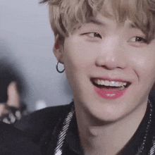 a close up of a person 's face with a smile on his face