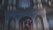 a person in a red and white cape is standing in front of a castle