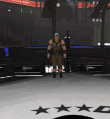 a man stands in a boxing ring with a monster energy sign behind him
