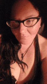 a woman wearing glasses and a black necklace