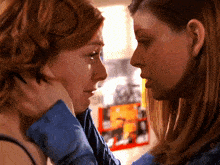 two women are looking at each other and one has a piercing