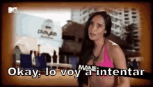a woman in a pink bikini is saying okay , lo voy a intentar .