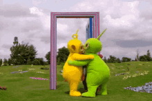 two teletubbies hug each other in front of a door