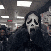 a man wearing a scream mask stands in front of a clock that says 4:02