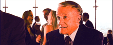 a man in a suit and tie is standing in a crowd of people