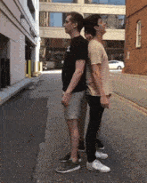 two men standing next to each other with one wearing a t-shirt that says ' sd ' on it