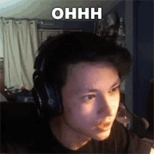 a young man wearing headphones with the word ohhh above his head