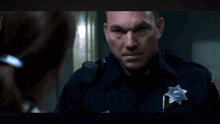a police officer with a badge that says sheriff