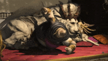 a lion wearing a crown is laying on a bed