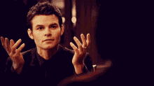 a man with a ring on his finger looks at another man